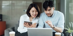 Couple considering mortgage payment options on computer
