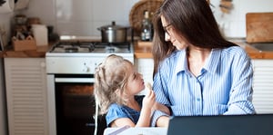 Woman working from home with child
