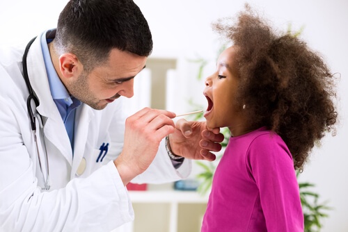 pediatrician doctor examining child patient for illness