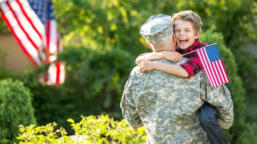 Veteran and son with flag