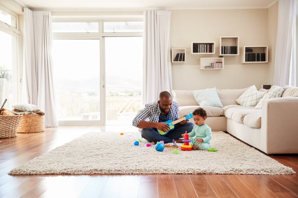 father playing with son on ground