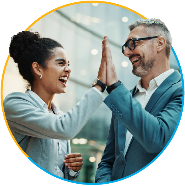 Smiling businessman and businesswoman high-fiving one another